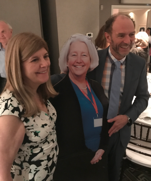 Dr. Jane Webber and Dr. Barry Mascari pose with a cutout of Dr. Carol Bobby during Carol's retirement party in 2017.